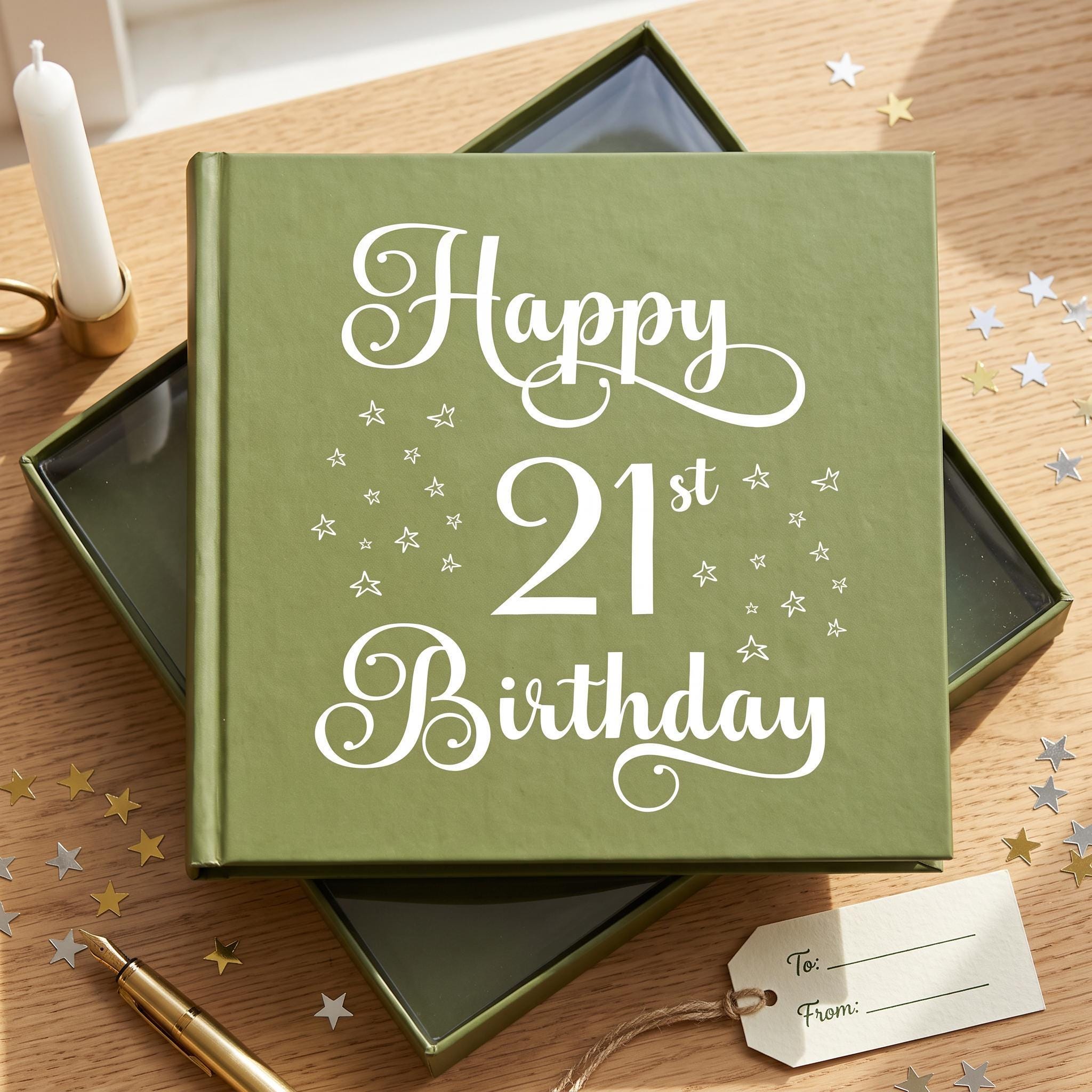 A green book titled "Happy 21st Birthday" with white stars on the cover, placed on a wooden surface with scattered gold stars.