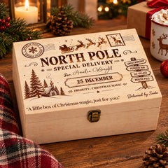 A wooden box with a Christmas-themed design, featuring a Santa Claus sleigh, pine trees, and a "North Pole Special Delivery" message.