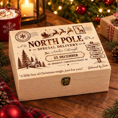 A wooden box with a Christmas-themed design, featuring a Santa Claus sleigh, snowflakes, pine trees, and a "North Pole Special Delivery" message.
