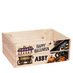 A wooden crate with a Halloween-themed design, including a trick or treat wagon, a spider, and a pumpkin.
