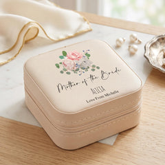 A beige jewelry case with a floral design and text that says "Mother of the Bride" and "Alicia Love From Michelle".