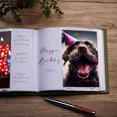 a birthday card with a photo of a dog wearing a party hat and surrounded by colorful confetti, placed on a wooden surface next to a pen.