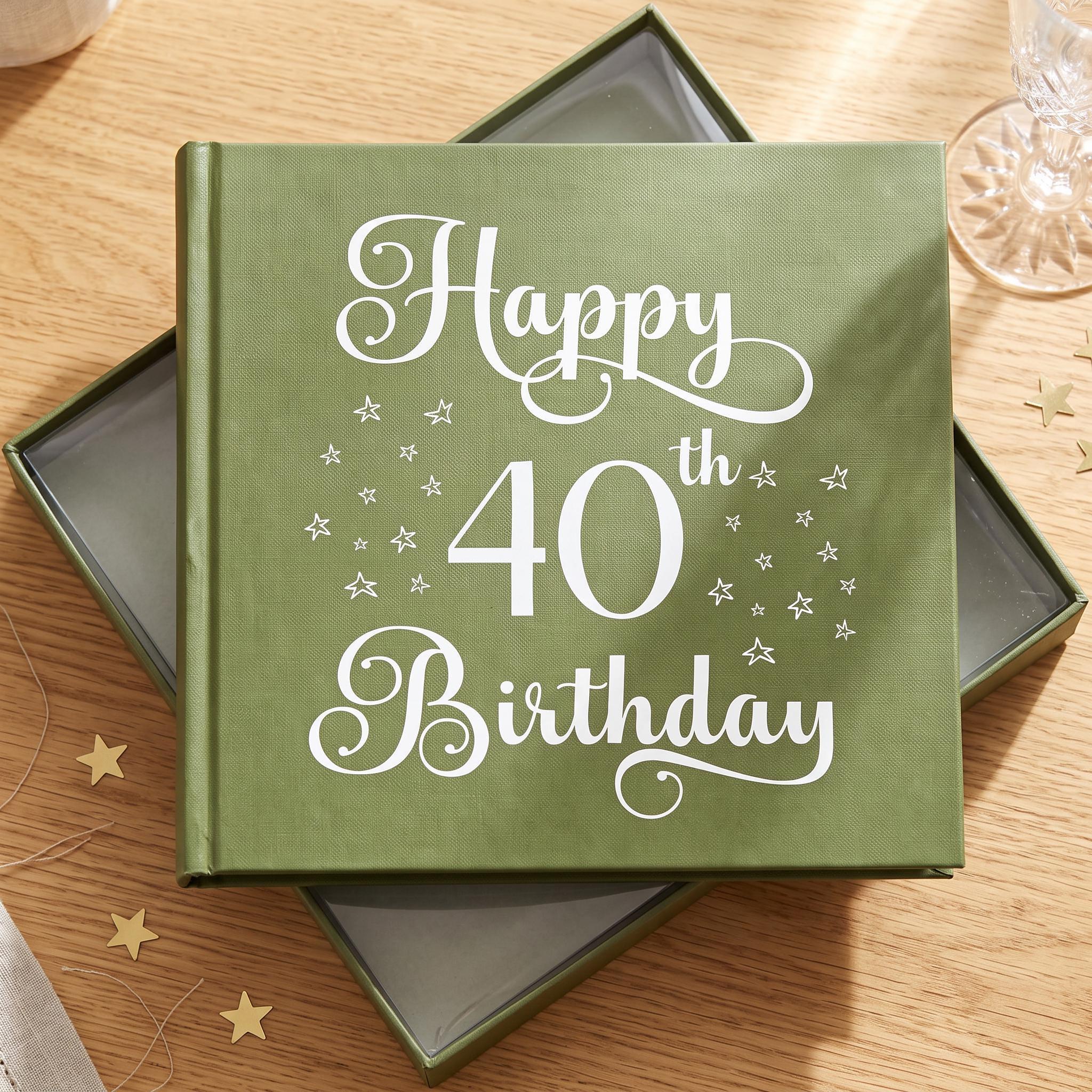 A green book titled "Happy 40th Birthday" with white text and stars on the cover, placed on a wooden surface.