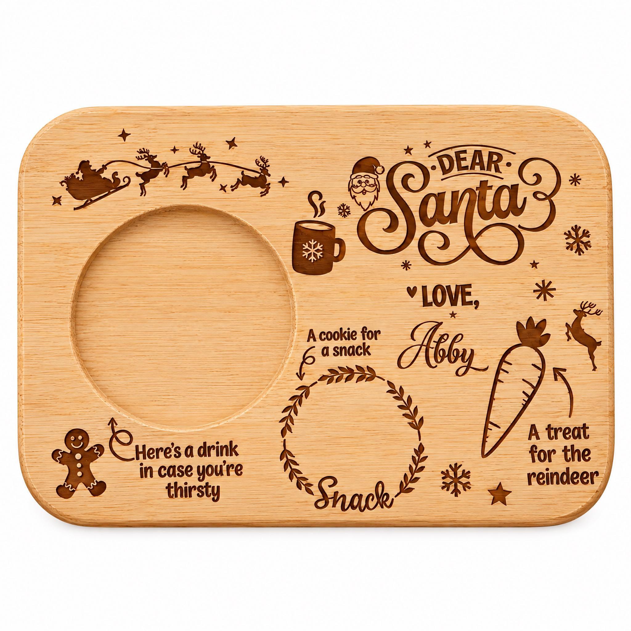 The image is a wooden tray with various Christmas-themed illustrations and text. It includes a Santa Claus sleigh, a cookie, a carrot, a treat for the reindeer, and a cookie for a snack. The text on the tray includes phrases like "Dear Santa", "Love", "Here's a drink in case you're thirsty", and "A treat for the reindeer". The overall layout and design of the tray suggest it is a personalized or handmade item, possibly for a Christmas-themed gift or decoration.