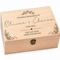A wooden box with the text "Wedding Memories of Oliver & Claire" engraved on it, along with the date "30.06.2026" and the phrase "The day our forever began".