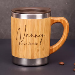 A wooden mug with a metal lid, featuring the name "Nanny" and the phrase "Love Jamieie" engraved on it.