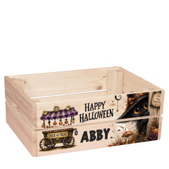 A wooden crate with a Halloween-themed design, including a trick or treat wagon, a black cat, and a "Happy Halloween" message.
