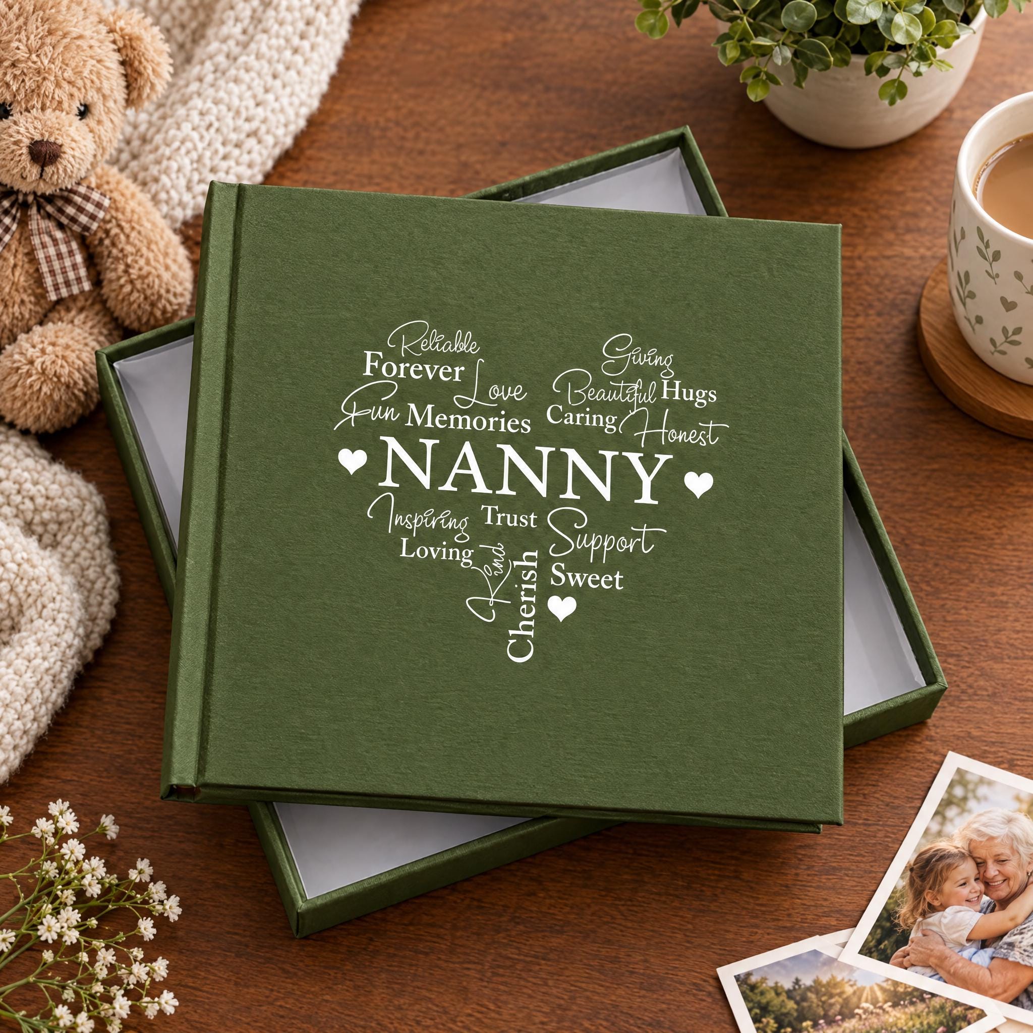 a green box with the word "NANNY" written on it, surrounded by various objects such as a teddy bear, a mug, and some flowers.