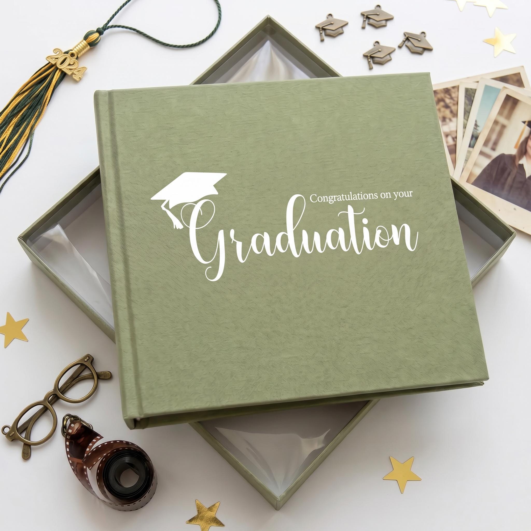 a graduation-themed photo album with a graduation cap and tassel, surrounded by graduation photos, a graduation cap, and a graduation gown.