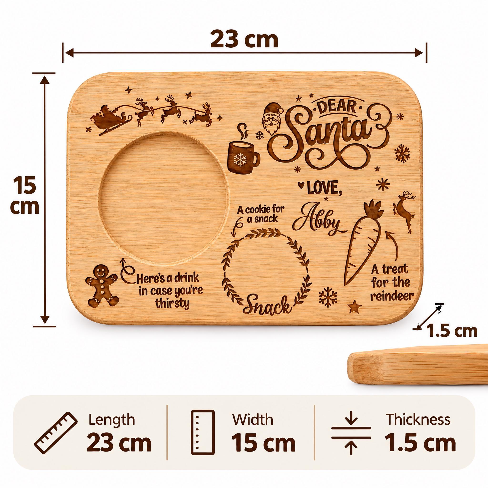 The image is a wooden tray with various Christmas-themed designs and text, including a Santa Claus figure, a cookie, a carrot, and other festive elements. The tray is approximately 23 cm in length, 15 cm in width, and 1.5 cm in thickness.