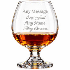A glass of amber-colored liquid, likely whiskey or scotch, with the text "Any Message Any Font Any Name Any Occasion" engraved on it.
