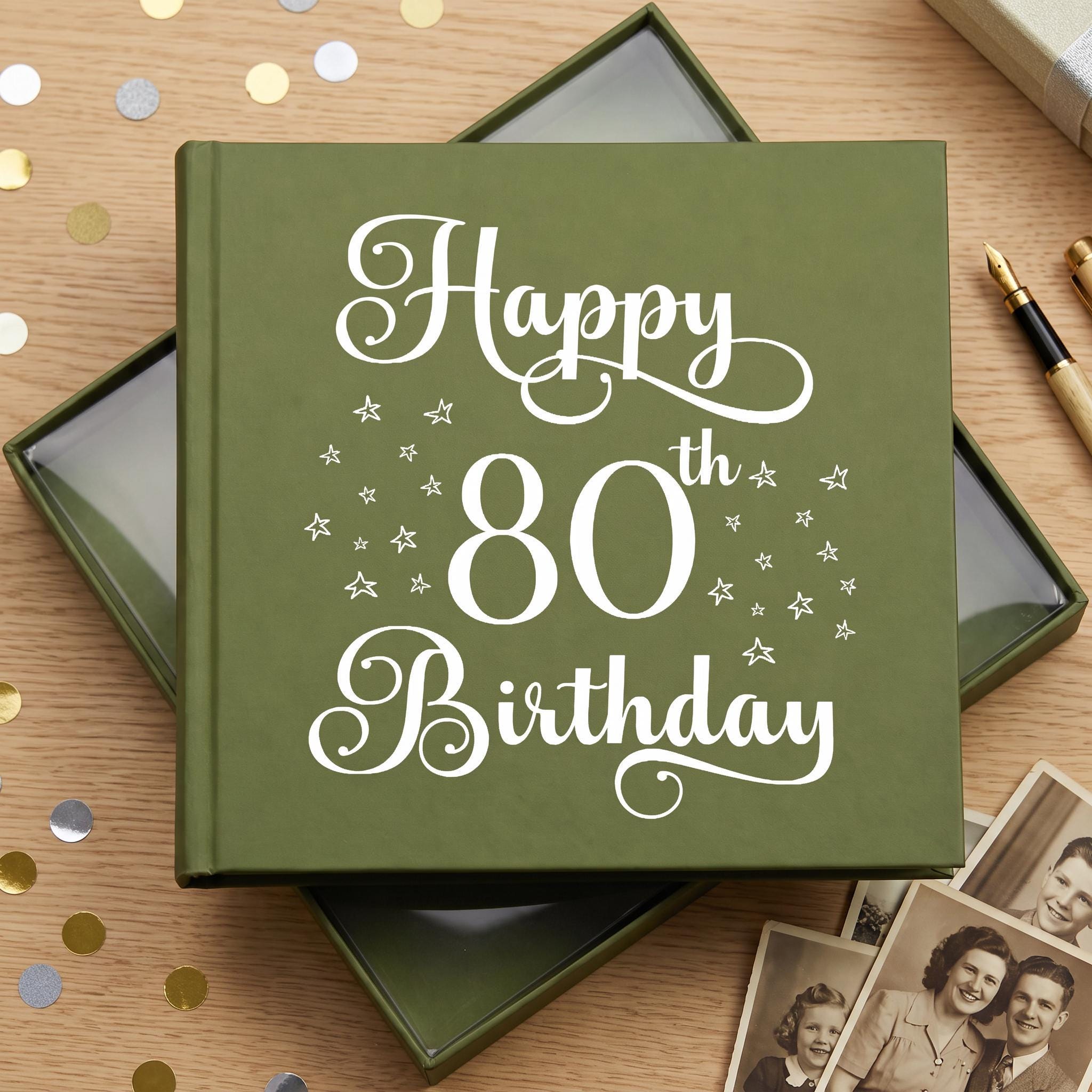 A green photo album with the text "Happy 80th Birthday" printed on it, surrounded by confetti and some photographs.