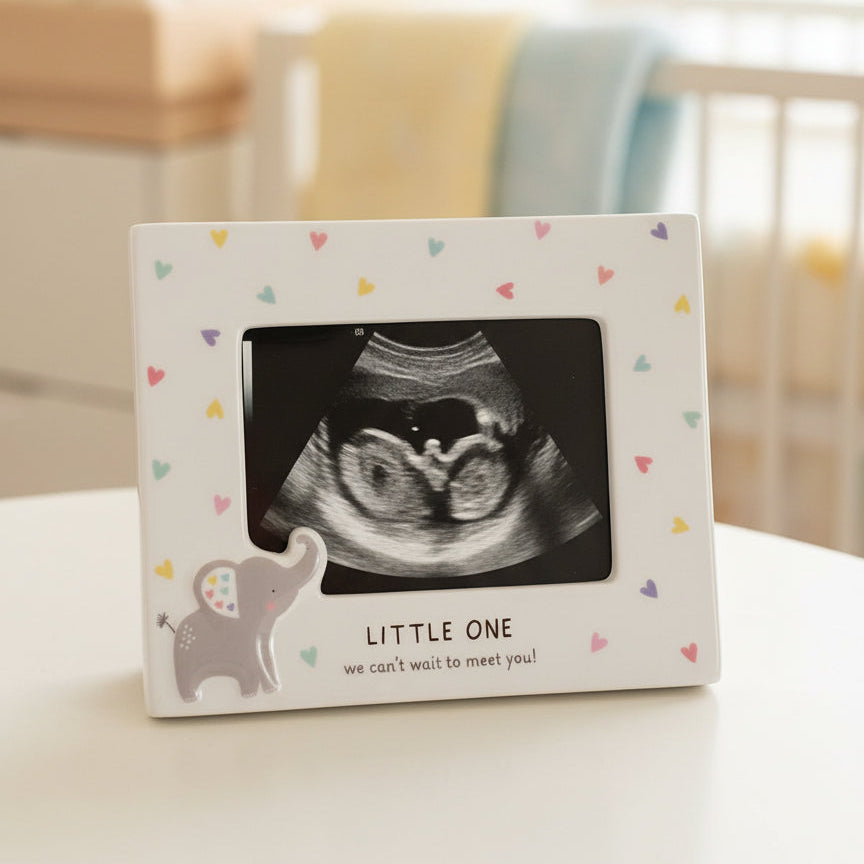Framed ultrasound photo with 'Little One' text on a table