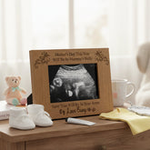 Wooden frame with ultrasound picture on a table with baby items