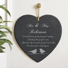 A heart-shaped sign with the names "Mr & Mrs Robinson" and a fairy tale ending message, accompanied by a pair of birds.