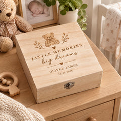 A wooden box with a personalized message engraved on it, placed on a wooden surface.