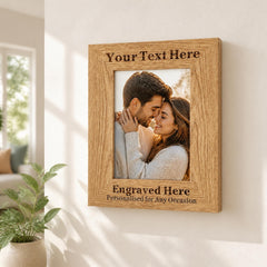 A wooden picture frame with a photo of a couple embracing, and the frame has text engraved on it that says "Your Text Here" and "Engraved Here Personalised for Any Occasion".