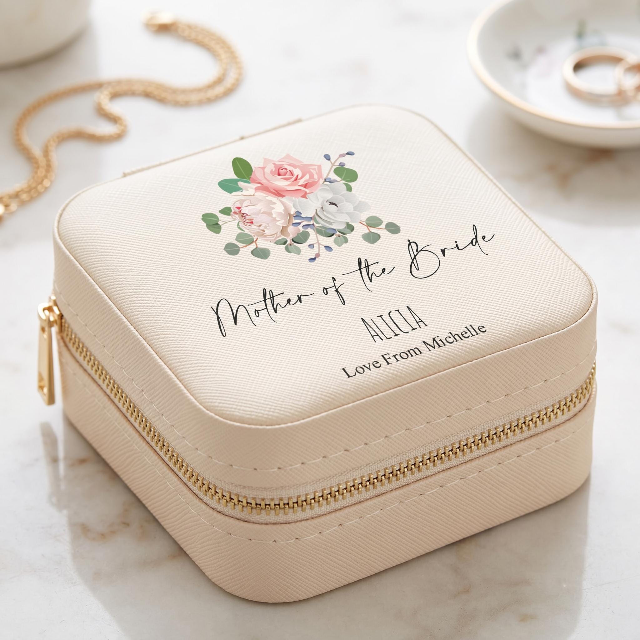 A beige jewelry case with a floral design and text that says "Mother of the Bride" and "Love From Michelle" printed on it.