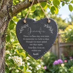 a heart-shaped slate sign hanging from a tree branch, with a message about staying connected and cherishing memories.