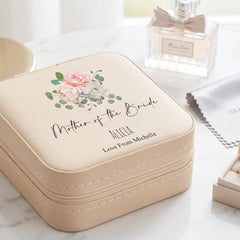A beige cosmetic case with a floral design and text that says "Mother of the Bride" and "ALICEa Love From Michelle" printed on it.