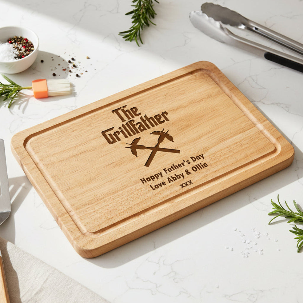 Wooden cutting board with 'The Grillfather' engraving on a kitchen counter.