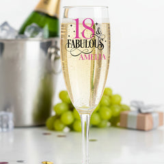 Champagne flute with '18 & Fabulous' text, bottle, and grapes on a celebratory background