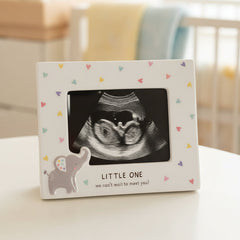 Framed ultrasound photo with 'Little One' text on a table